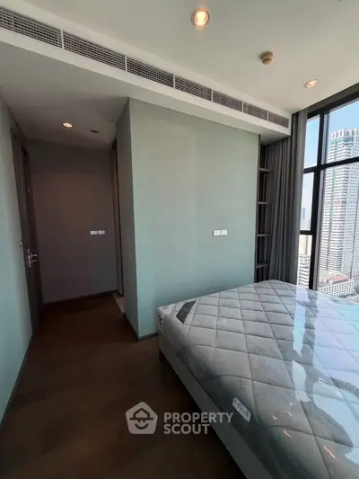 Modern bedroom with city view and sleek design in high-rise apartment