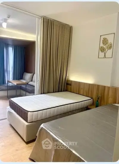 Modern bedroom with stylish decor and cozy seating area, perfect for relaxation and comfort.