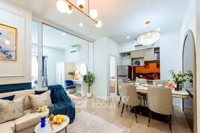 Luxurious open-plan living and dining area with modern decor and elegant lighting.