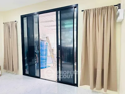 Spacious room with sliding glass doors leading to a covered outdoor area.