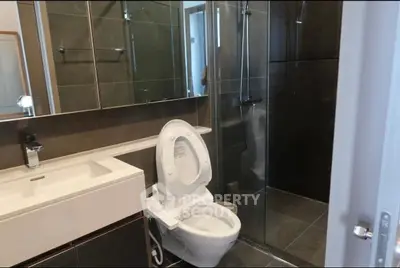 Modern bathroom with sleek fixtures and glass shower enclosure