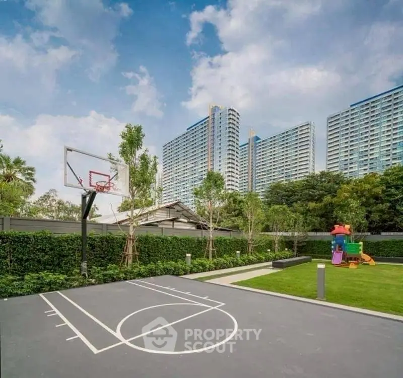 Modern residential complex with basketball court and playground, ideal for family living.