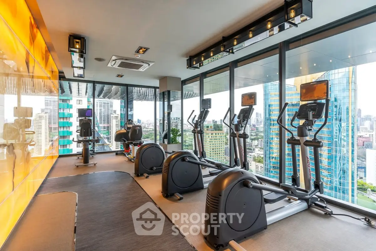 Luxurious high-rise gym with panoramic city views and modern fitness equipment.