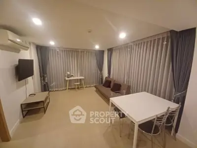 Spacious living room with modern furniture and large windows for natural light.