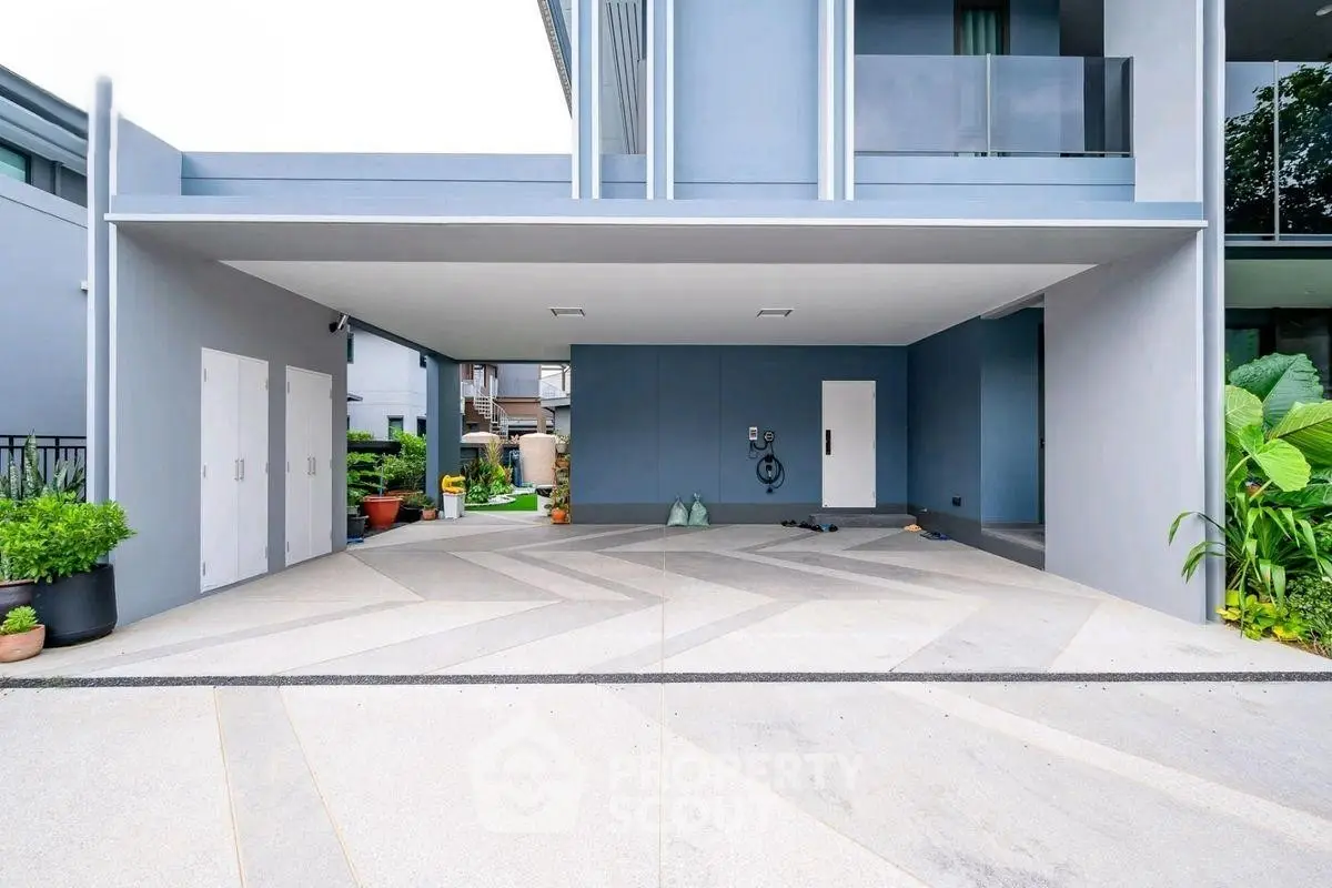 Modern residential building with spacious covered parking area and sleek design.