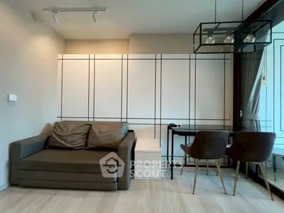 Modern living room with sleek sofa and dining area in stylish apartment.