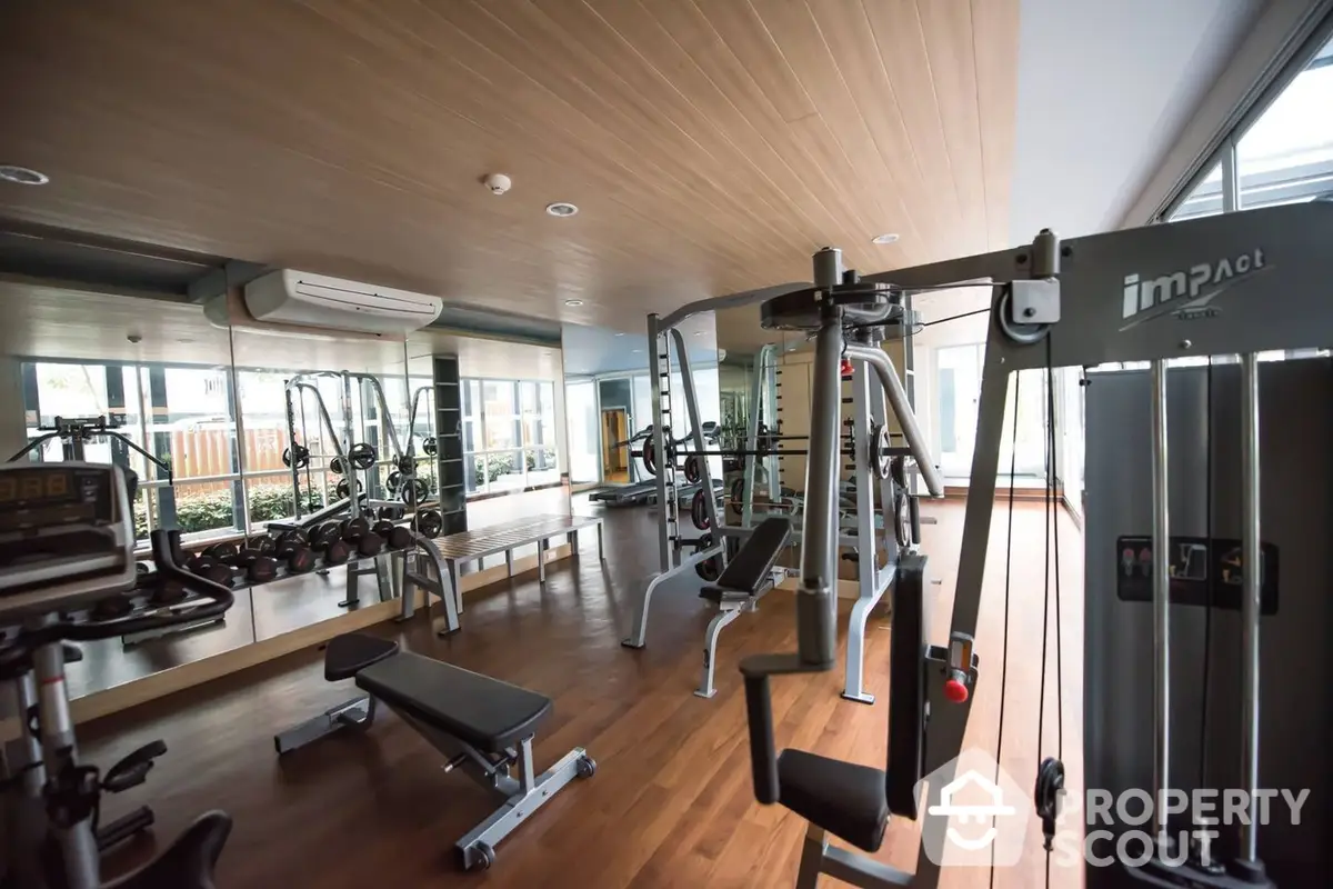 State-of-the-art gym facility in a modern residential complex with high-end equipment and a spacious layout, perfect for fitness enthusiasts.