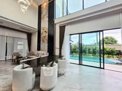 Luxurious modern living room with high ceilings and pool view