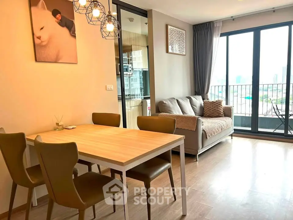 Modern living room with dining area and balcony view in stylish apartment