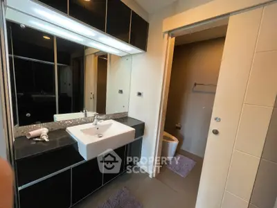 Modern bathroom with sleek black cabinetry and stylish fixtures