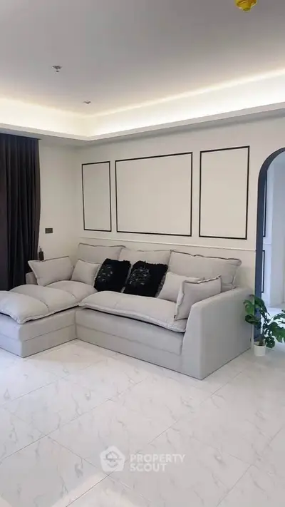 Modern living room with elegant sofa and stylish decor in a contemporary apartment.