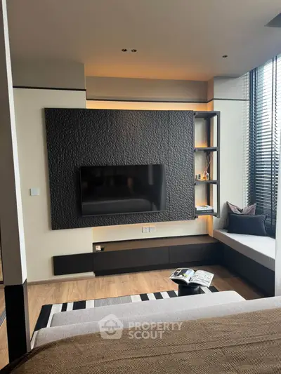Modern living room with sleek TV wall and cozy seating area