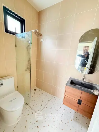 Modern bathroom with sleek fixtures and glass shower enclosure