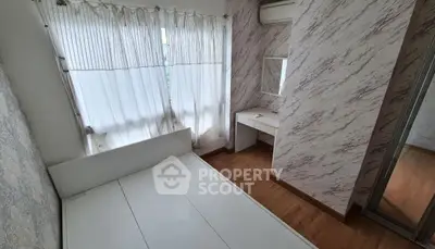 Cozy bedroom with elegant marble wallpaper and natural light
