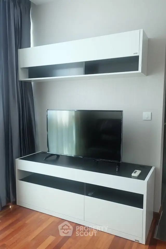 Modern living room with sleek TV stand and wall-mounted storage unit