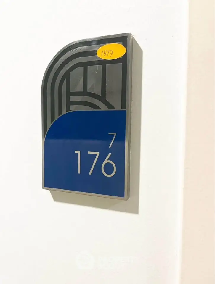 Modern apartment number sign with sleek design and blue accent, indicating unit 176.