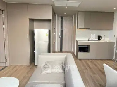 Modern open-plan kitchen and living area with sleek design and neutral tones.