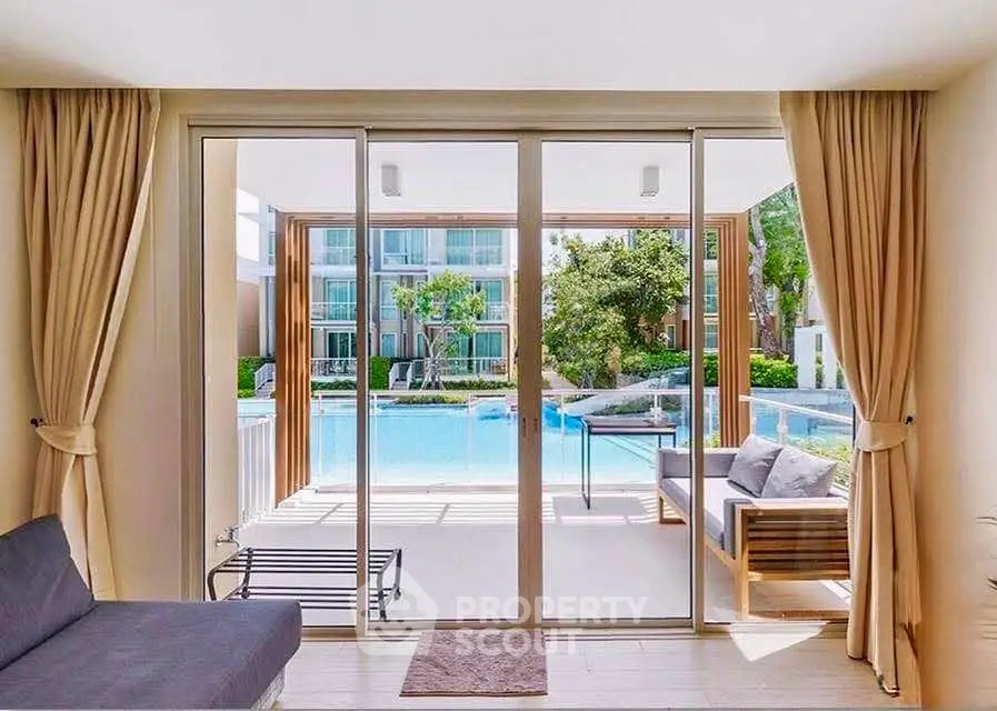 Luxurious living room with pool view and elegant sliding glass doors