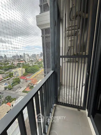 High-rise balcony with city view and safety netting, perfect for urban living.