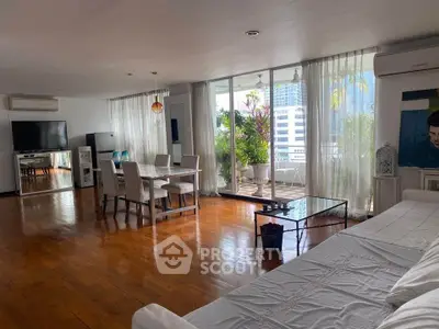 Spacious living room with large windows and balcony in modern apartment
