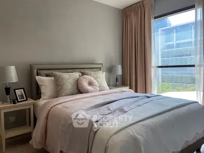 Cozy and elegant bedroom with stylish decor and large window offering natural light.