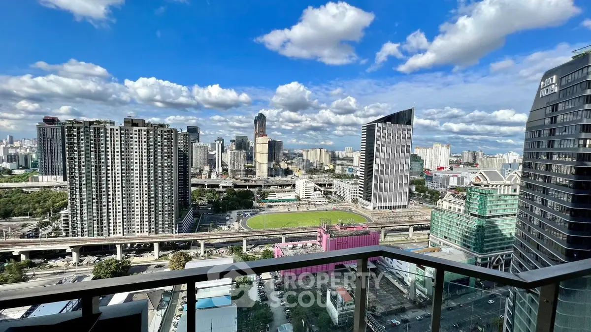 Stunning cityscape view from a high-rise balcony showcasing urban skyline and vibrant architecture.