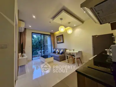 Modern living room with open kitchen and balcony view, featuring stylish decor and contemporary lighting.