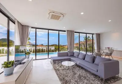 Luxurious living room with panoramic windows and pool view