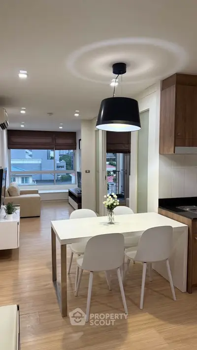 Modern open-plan living and dining area with stylish decor and natural light.