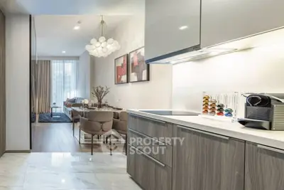 Modern open kitchen and living room with sleek design and elegant lighting
