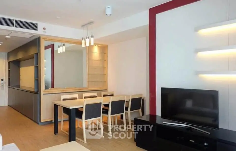Modern living room with dining area, sleek furniture, and ambient lighting.