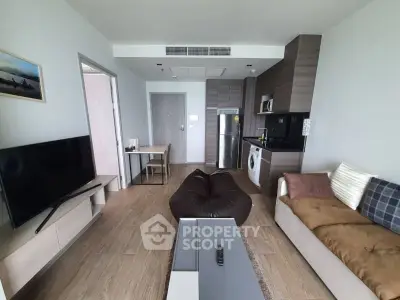 Modern living room with stylish furniture and appliances in a cozy apartment.