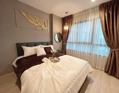 Elegant bedroom with cozy decor and large window draped in luxurious curtains.