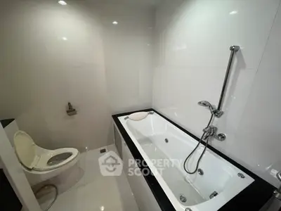 Modern bathroom with sleek white tiles and luxurious bathtub