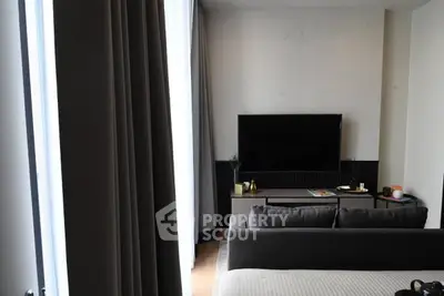 Modern living room with sleek TV setup and cozy seating area