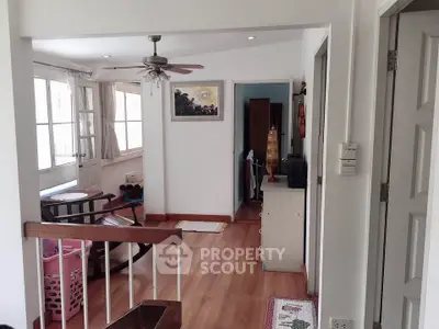Charming interior with wooden flooring and ceiling fan, perfect for cozy living.