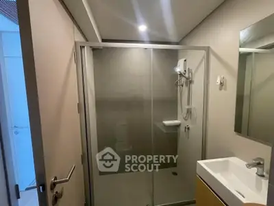 Modern bathroom with glass shower enclosure and sleek vanity