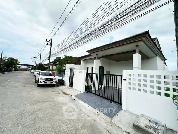 Charming suburban house with gated entrance and driveway in a quiet neighborhood.