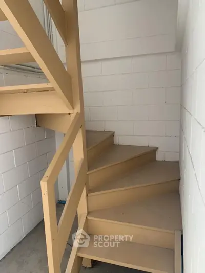 Modern industrial staircase with beige metal steps and white brick walls