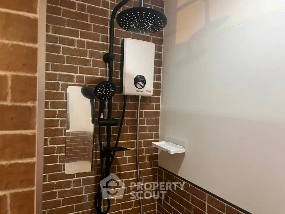 Modern bathroom with stylish brick wall and dual shower heads for a luxurious experience.