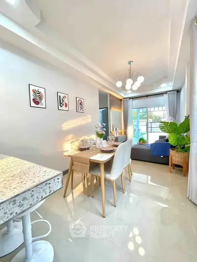 Stylish open-plan living and dining area with modern decor and natural light.