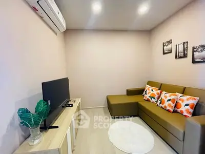 Cozy living room with modern sofa and TV setup, perfect for relaxation.