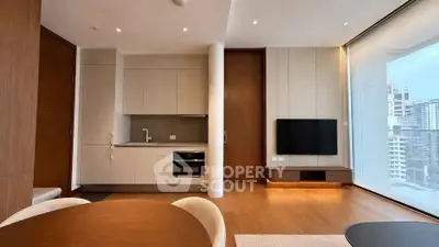 Modern open-plan living room with kitchen and city view, featuring sleek design and natural light.