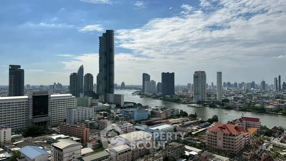 Stunning cityscape view with river and skyscrapers under a clear blue sky.