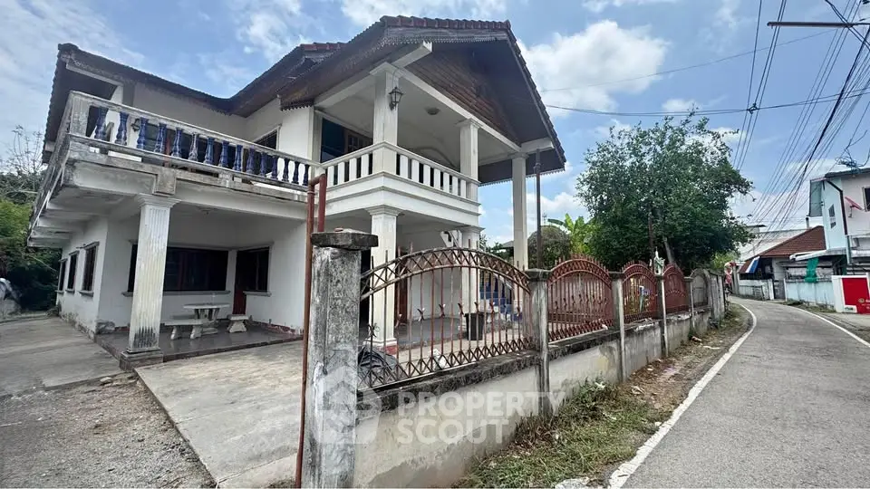 Charming two-story house with balcony and spacious driveway in a serene neighborhood.