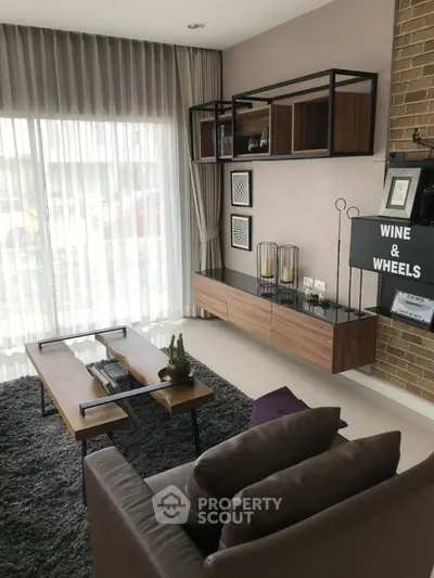 Modern living room with stylish furniture and large window for natural light.