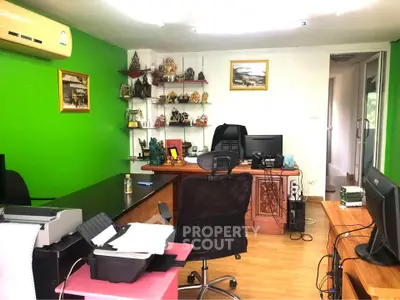 Modern home office with vibrant green accent wall and organized workspace.