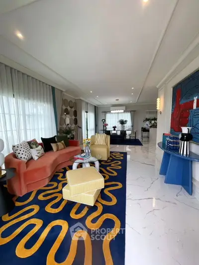 Luxurious living room with modern decor and vibrant rug in elegant home.