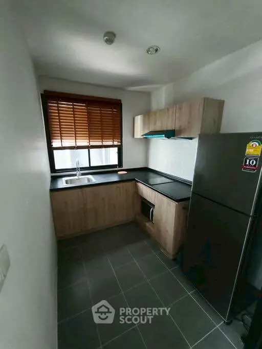 Modern compact kitchen with sleek cabinets and stainless steel appliances