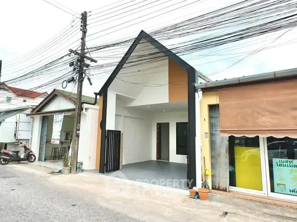 Modern minimalist house exterior with unique roof design and spacious entrance